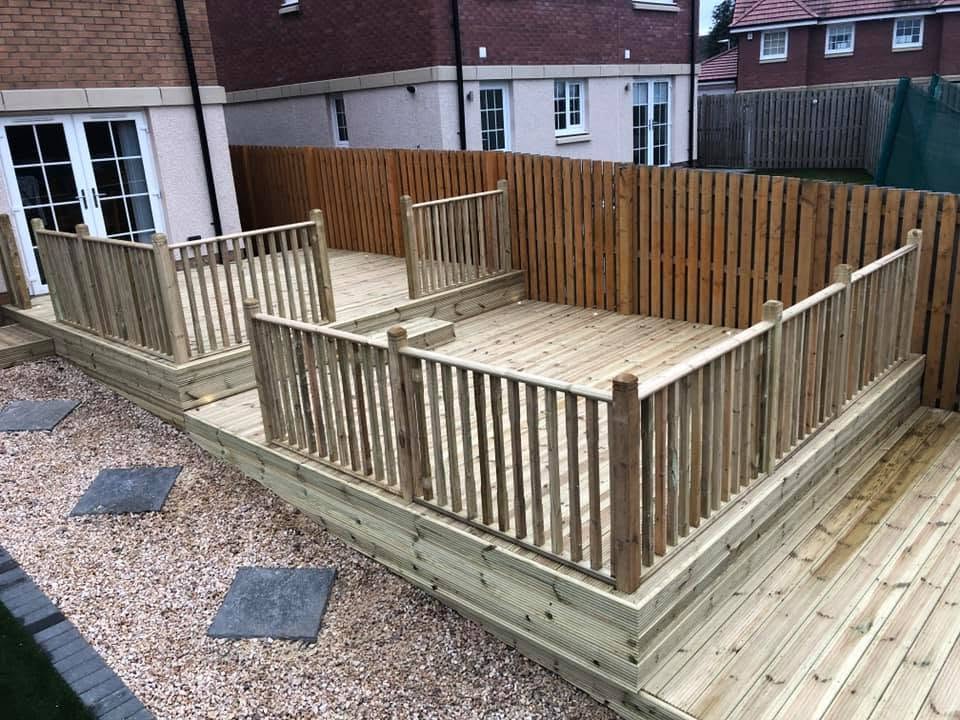Newly built timber decking with railings in a rear garden